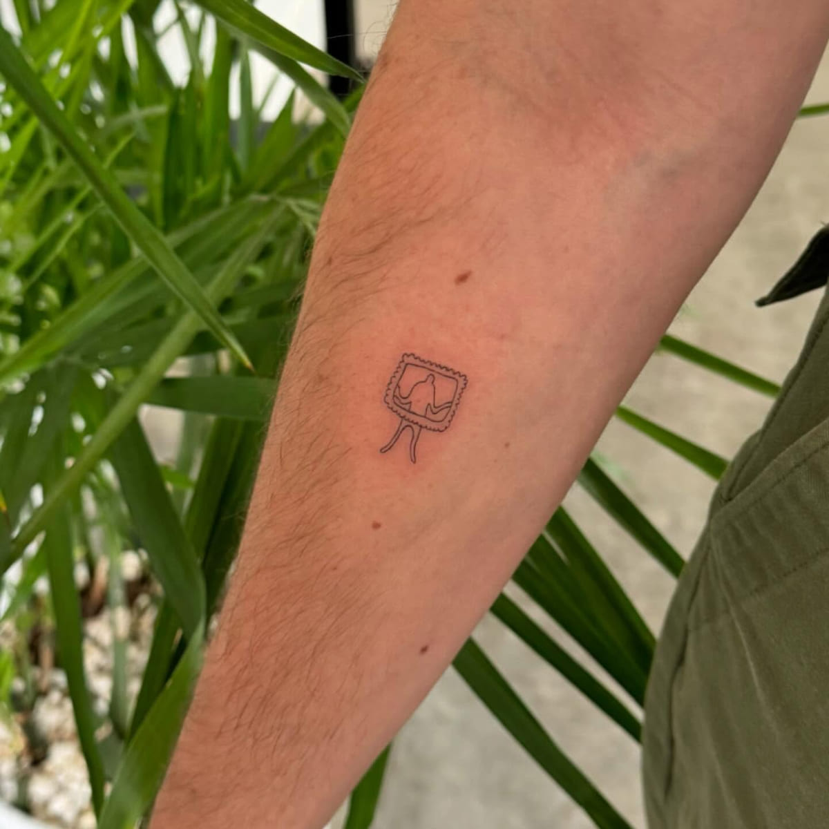 Tiny television set with a heart, fine line tattoo