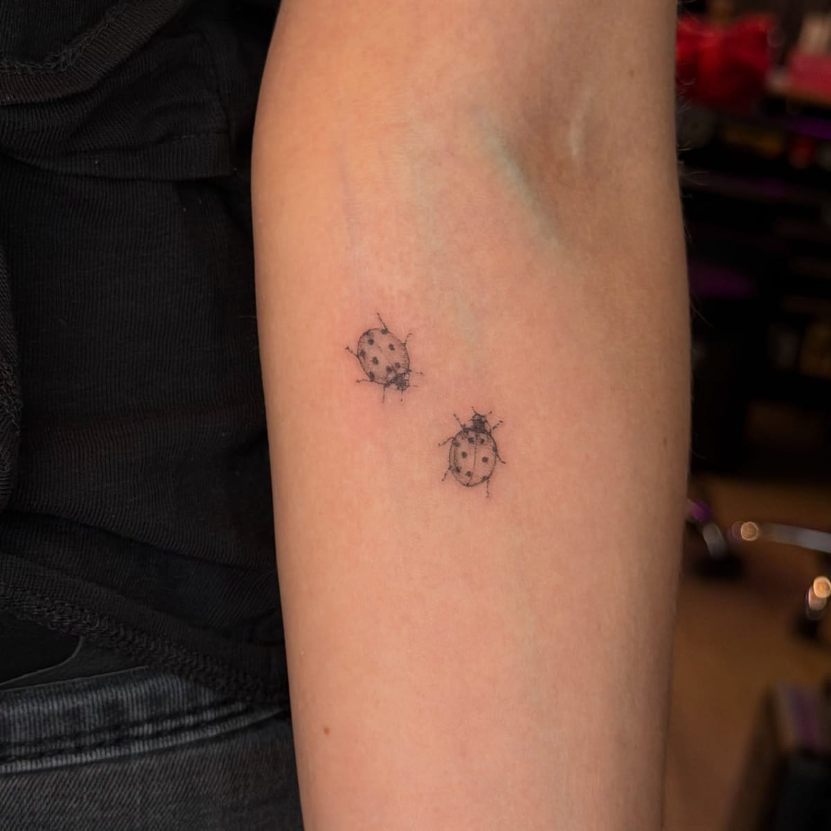 Two ladybugs, fine line tattoo