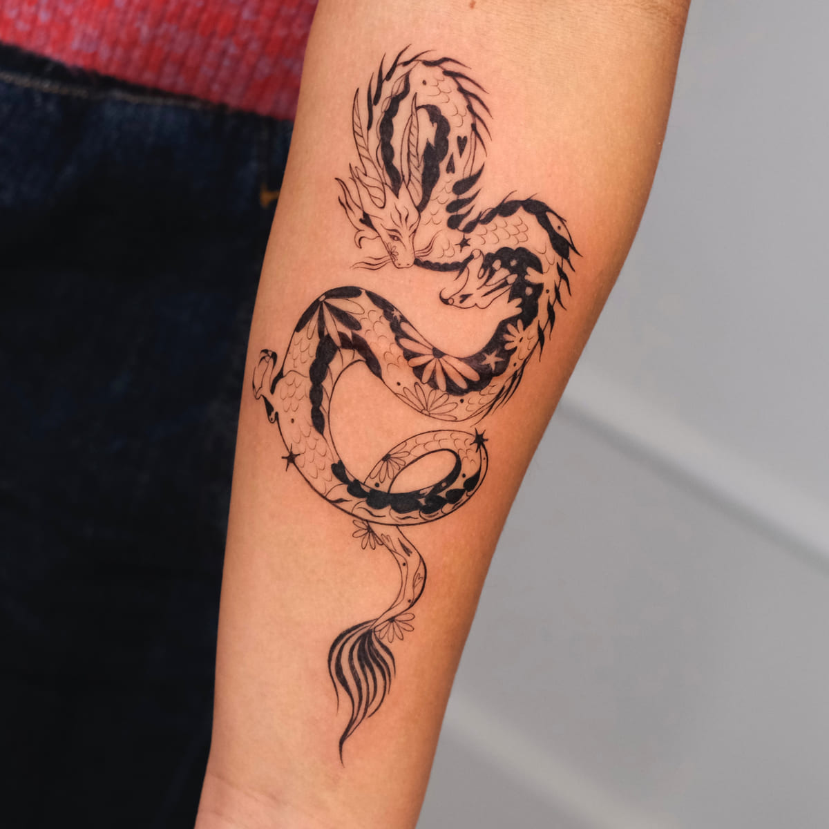 Coiled dragon with patterned body, fine line tattoo