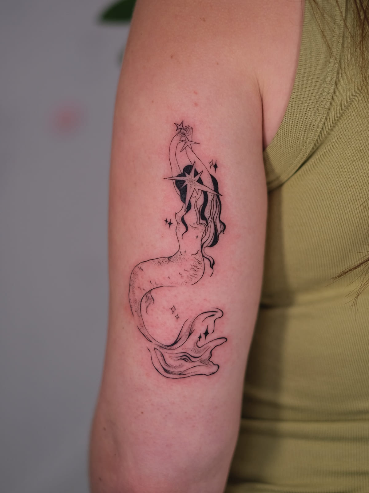 Mermaid reaching up to a star, fine line tattoo