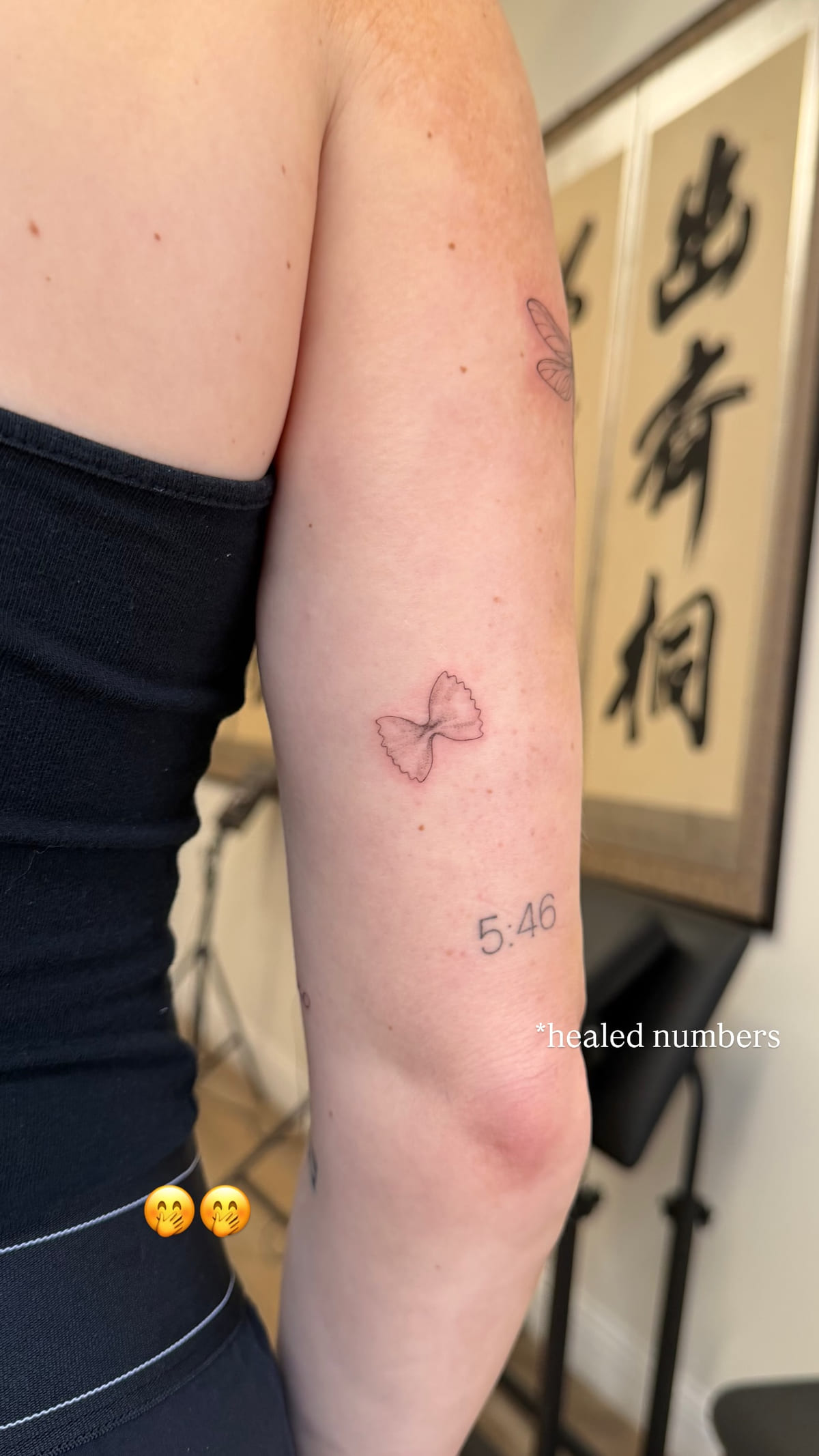 Red bow and the numerals 5:46, healed fine line tattoo, healed