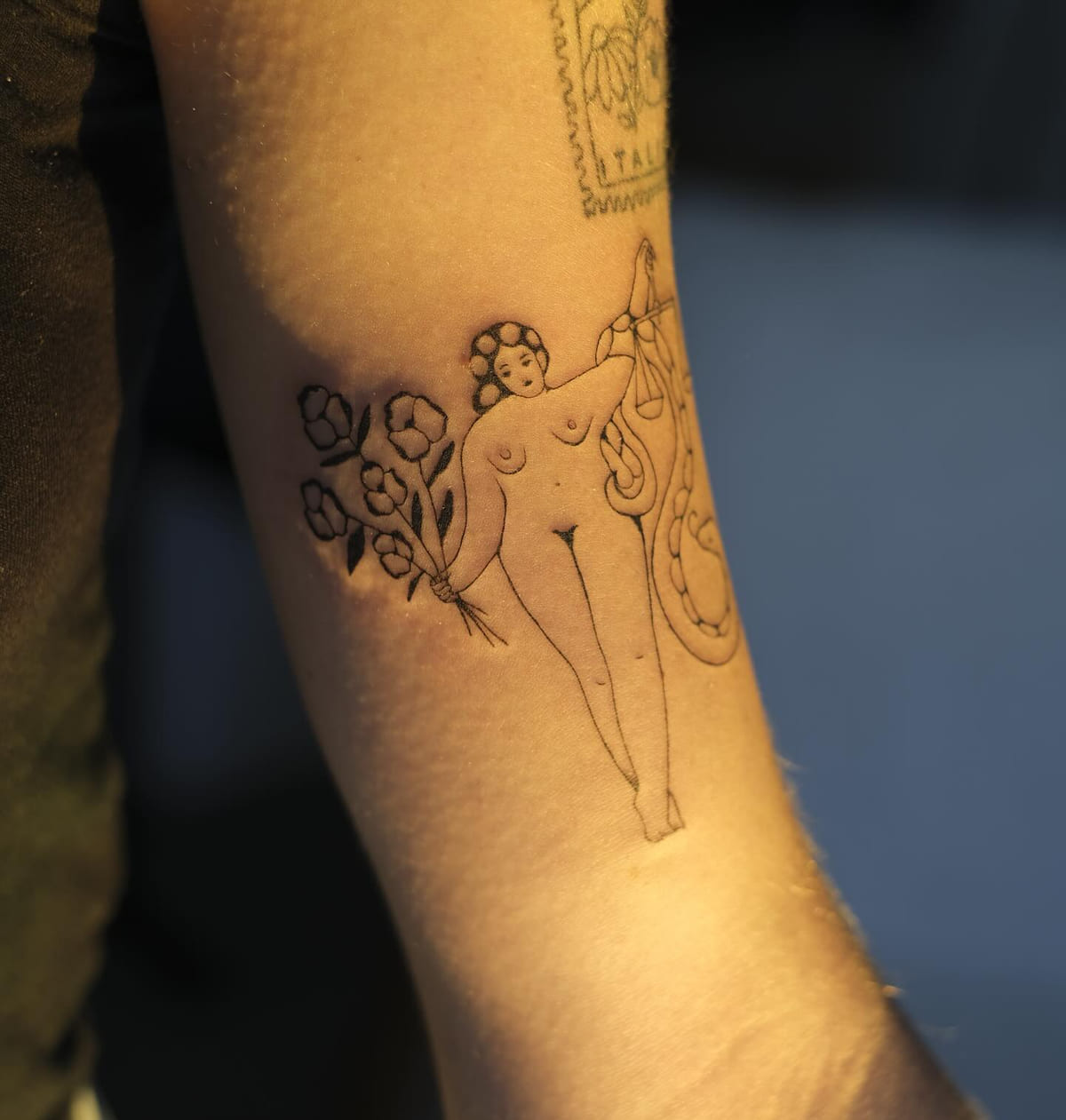 Nude figure holding flowers, with a snake, fine line tattoo