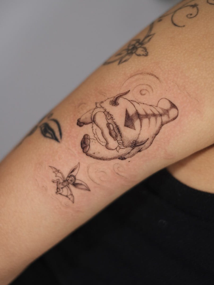 Two animated series creatures, a flying bison and a winged lemur, soft shaded with faint wind swirls, another view