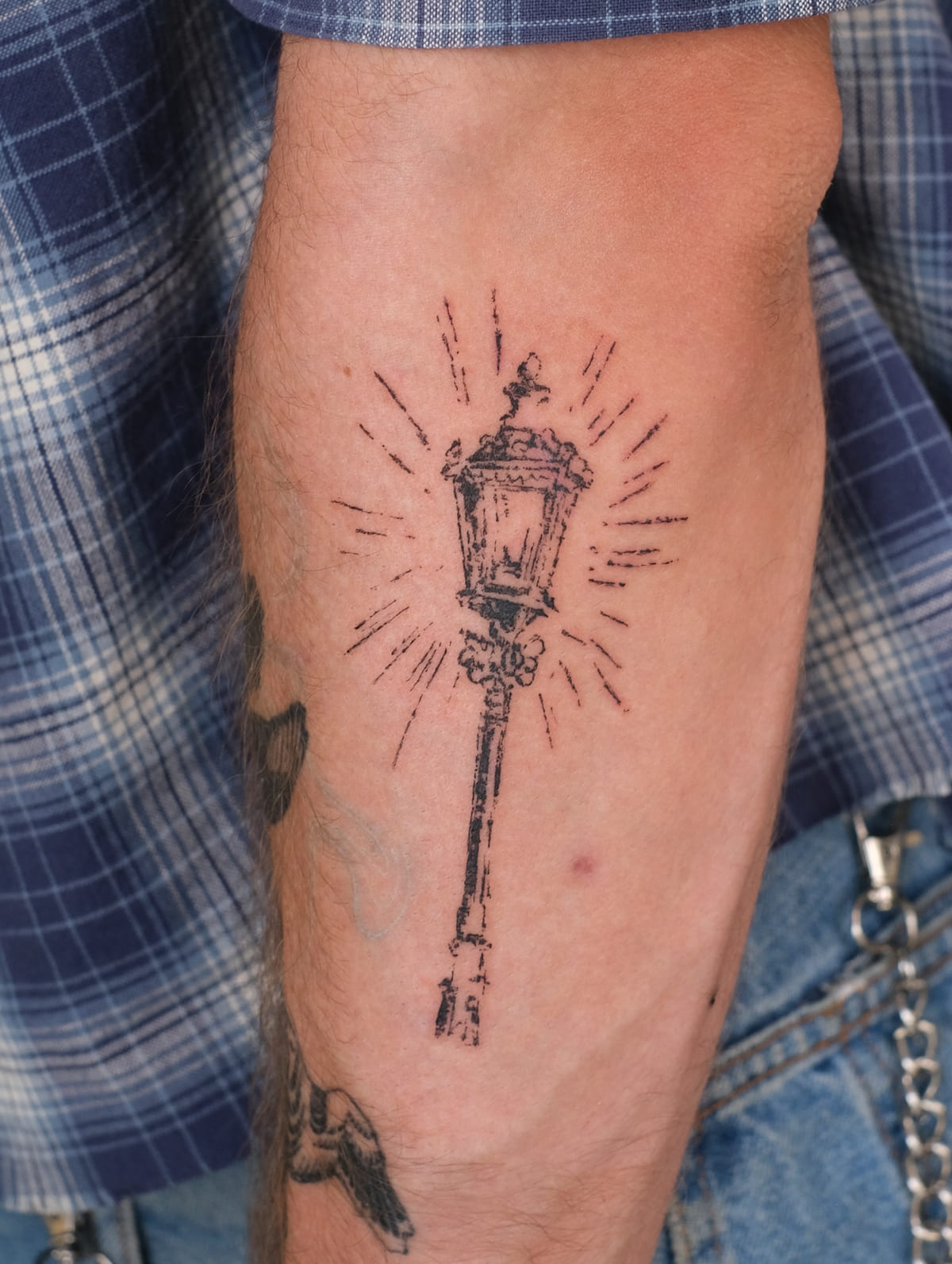 Glowing street lantern on a tall post, another view
