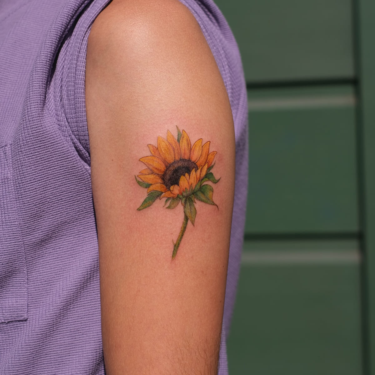 Sunflower in full color, fine line tattoo