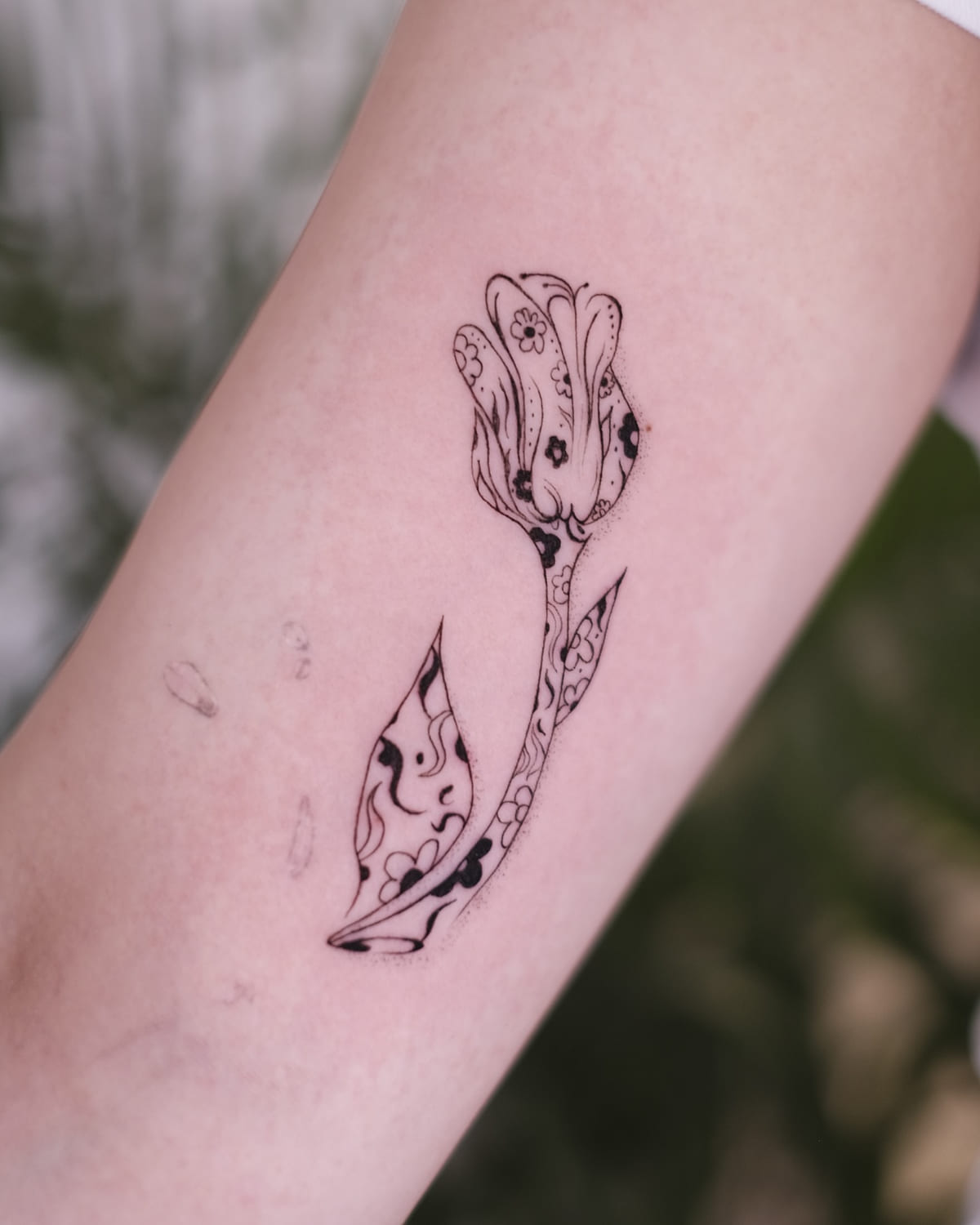 Tulip with pattern filled petals and leaves, fine line tattoo