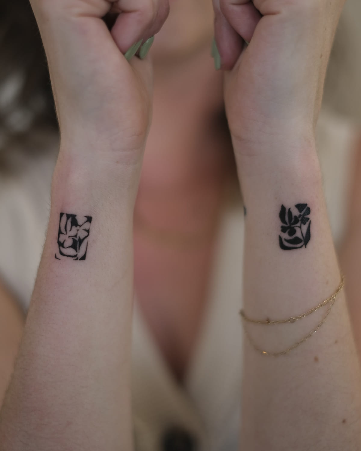 Two solid black flower blocks, one on each wrist, another view