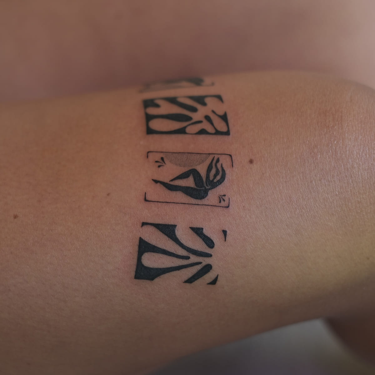 Band of four Matisse cut outs above the knee: leaf forms and blue nudes in solid black, another view