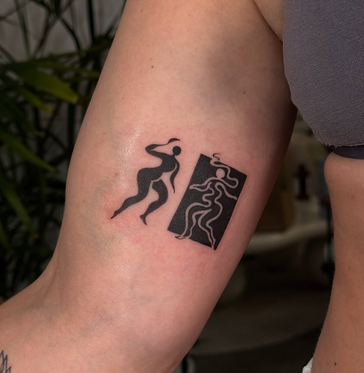 Two cut out dancers, one solid and one in negative space, fine line tattoo
