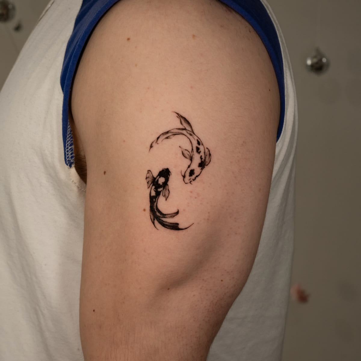 Two koi circling, fine line tattoo