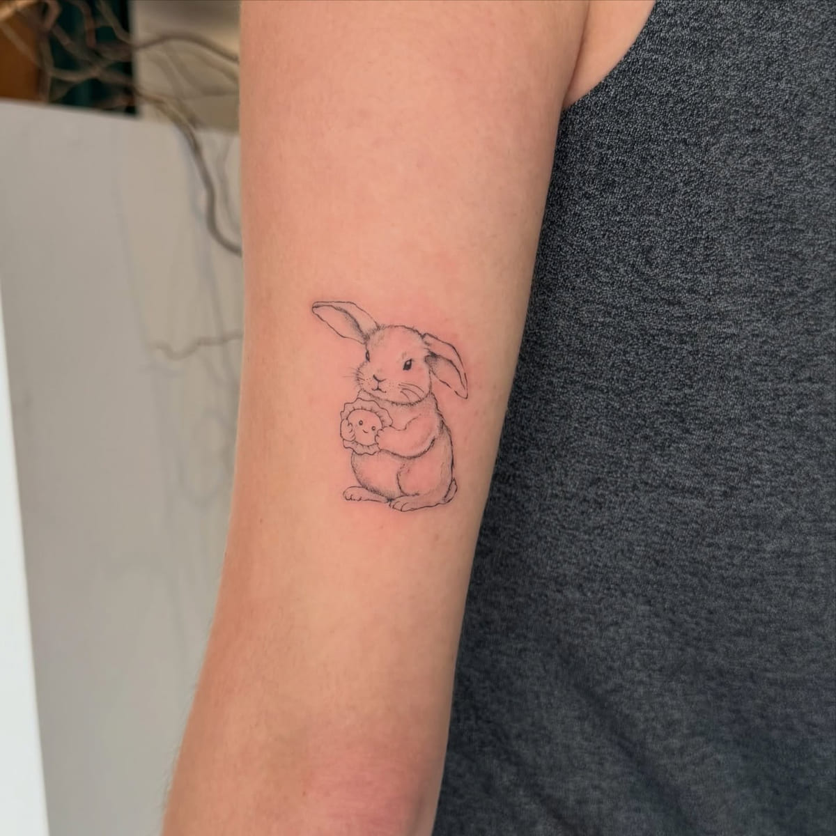 Rabbit hugging a smaller one, fine line tattoo