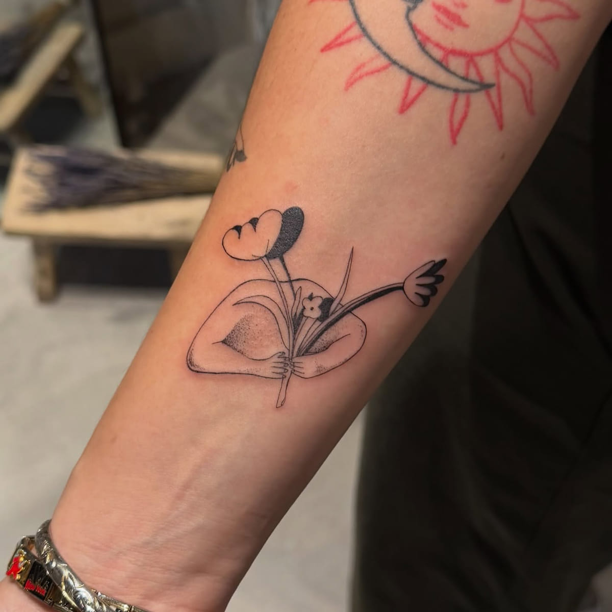 Surreal bust holding tulips, flowers in place of the head, fine line tattoo