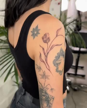 Tulips wrapping the upper arm, fine line tattoo