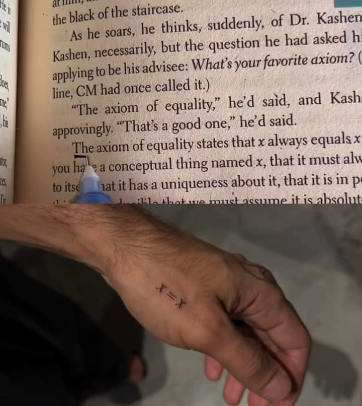 Tiny x = x on the hand, shown with the book page it comes from, fine line tattoo