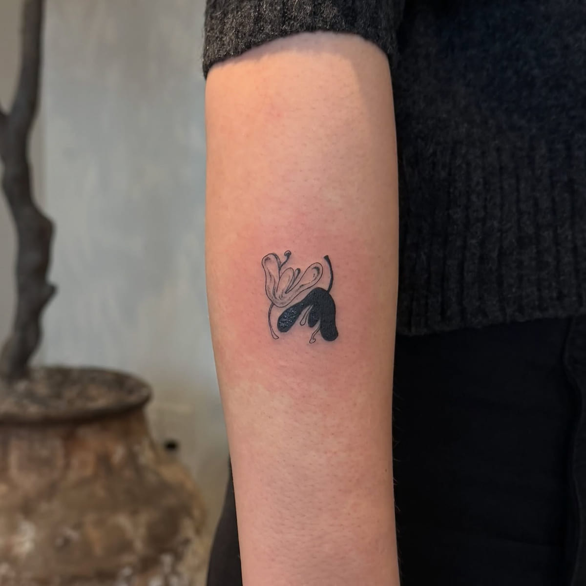 Abstract solid black shape with a floral swirl, another view