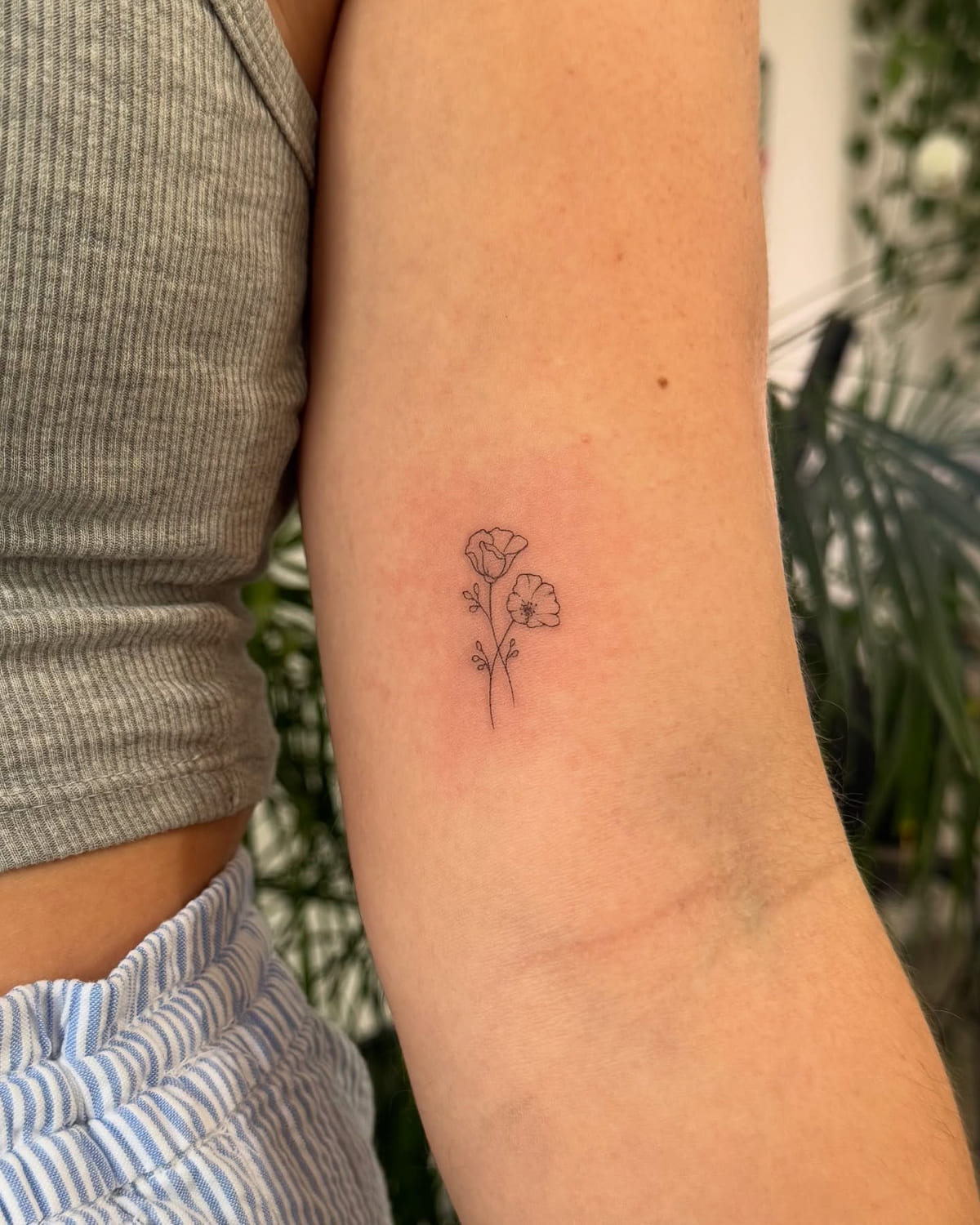 Two tiny poppies, fine line tattoo