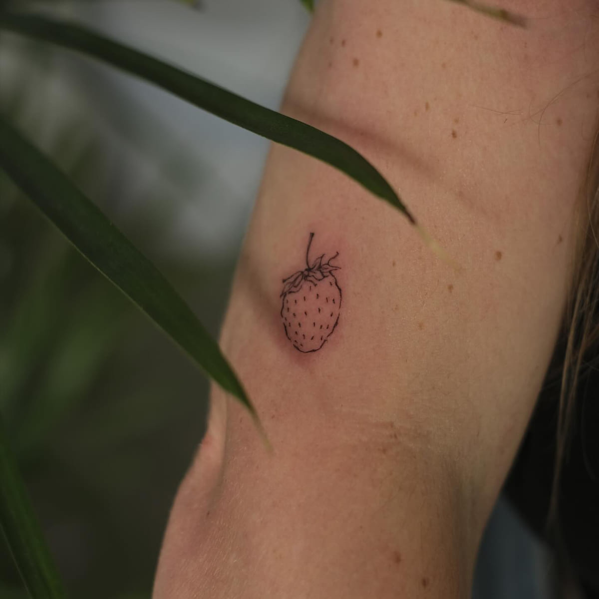 Tiny strawberry, fine line tattoo