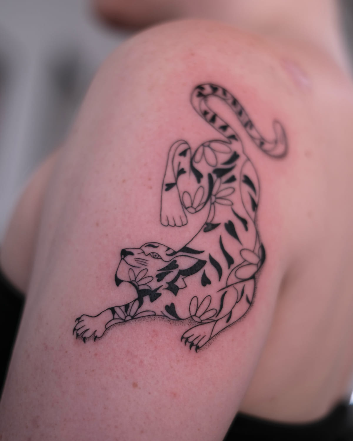 Prowling tiger filled with leaves, fine line tattoo