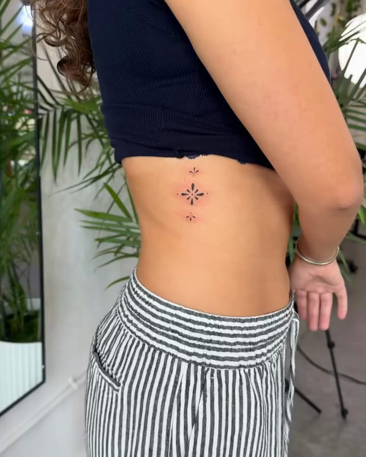 Small vertical ornament of three marks, fine line tattoo